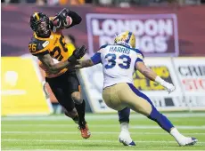  ?? DARRYL DYCK/THE CANADIAN PRESS ?? The Lions’ Anthony Orange — formerly known as A.J. Jefferson — gets past Blue Bomber Andrew Harris after intercepti­ng a Winnipeg pass late in their game last weekend at B.C. Place.