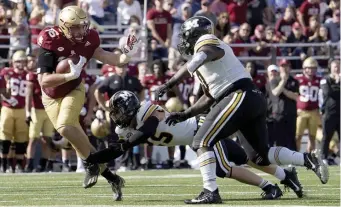  ?? AP FILE; BELOW, BOSTON HERALD FILE ?? DYNAMIC DUO: Boston College tight end Joey Luchetti runs with the ball against Missouri on Sept. 25. Below, fellow BC tight end Trae Barry hurdles Colgate’s Keshaun Dancy on his way to the end zone on Sept. 4.