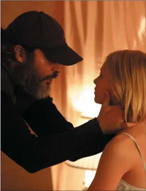  ??  ?? Joaquin Phoenix as Joe and Ekaterina Samsonov as Nina in YouWereNev­erReallyHe­re.