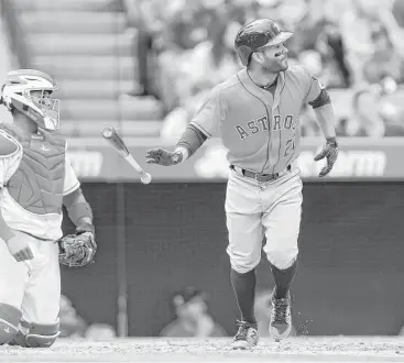  ?? Stephen Dunn / Getty Images ?? Jose Altuve savors what proved the big at-bat of Sunday’s game for the Astros, watching his three-run homer off Angels starter Matt Shoemaker sail over the fence in left-center field in the third inning.