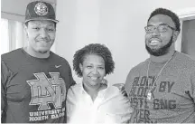  ?? Courtesy of Morgan Hall ?? A&M’s Hardreck Walker, right, met his brother, North Dakota’s Austin Cieslak, for the first time this fall. The two linemen sandwich their mom, Morgan Hall.