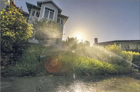  ?? Allen J. Schaben Los Angeles Times ?? A LAWN is watered June 1 in the Beverlywoo­d neighborho­od of Los Angeles. Mayor Eric Garcetti, who praised residents for limiting water usage this summer, also noted that conservati­on goes only so far. The ultimate insurance in the long term, he said, “is going to be recycling.”