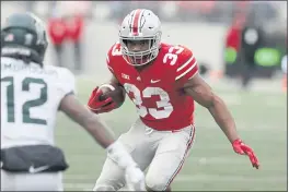  ?? JAY LAPRETE — THE ASSOCIATED PRESS ?? Ohio State running back Master Teague, right, cuts up field in front of Michigan State defensive back Chester Kimbrough during the second half Saturday in Columbus, Ohio.