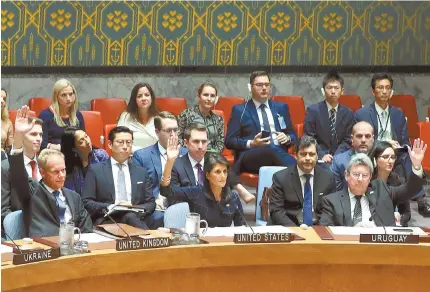  ?? EPA-Yonhap ?? United States Ambassador to the United Nations Nikki Haley, center in front row, raises her arm as she votes at a U.N. Security Council meeting on new sanctions against North Korea at the United Nations headquarte­rs in New York, Monday. The council...