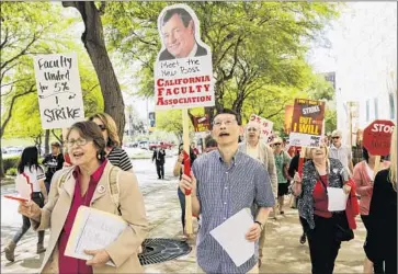  ?? Irfan Khan Los Angeles Times ?? THE CALIFORNIA Faculty Assn., which represents 26,000 professors, lecturers, counselors, librarians and coaches, has been demanding a 5% pay raise. Above, union members march this week at Cal Poly Pomona.