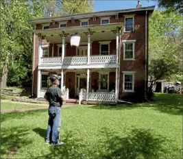  ?? Darrell Sapp/Post-Gazette ?? Edward Maslanka stands in front of his 1835 house in Ross. He rebuilt the two-story porch and replaced most of its balusters.