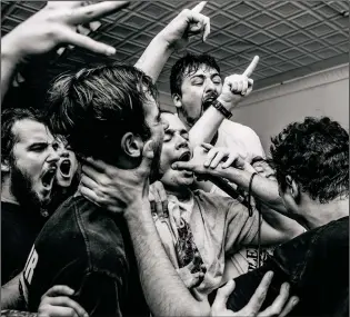  ?? Photo by Gabe Becerra ?? Vein vocalist Anthony DiDio shoves the mic into shouting fans.