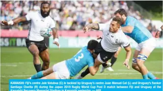  ?? — AFP ?? KAMAISHI: Fiji’s centre Jale Vatubua (C) is tackled by Uruguay’s centre Juan Manuel Cat (L) and Uruguay’s flanker Santiago Civetta (R) during the Japan 2019 Rugby World Cup Pool D match between Fiji and Uruguay at the Kamaishi Recovery Memorial Stadium in Kamaishi yesterday.