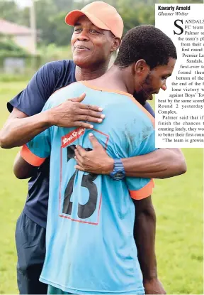  ?? FILE ?? Coach of Sandals South Coast Aaron ‘Wild Boy’ Lawrence celebrates with goalscorer Obrain Bent (front) after the team’s first win in the Red Stripe Premier League on November 13. This was a 1-0 win over Boys’ Town at the Frome Sports Complex.