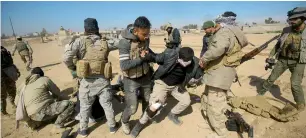  ?? AFP ?? Iraqi security forces evacuate comrades wounded in an explosives-laden vehicle attack claimed by Daesh group , south of Mosul. —