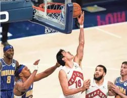  ?? AP ?? Raptors forward Yuta Watanabe (18) shoots in front of Pacers center Myles Turner (33) during the second half in Indianapol­is on Sunday.