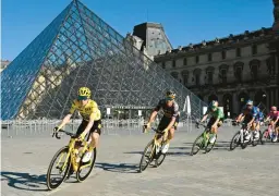  ?? BERTRAND GUAY/AP ?? Jonas Vingegaard, front, races past the Louvre Museum during the 21st stage of the Tour de France on Sunday.