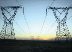  ?? ?? Eskom power lines run through an open field as the sun rises on a cold winter’s day in Johannesbu­rg in June 2015.