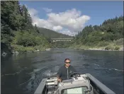  ?? NATHAN HOWARD — THE ASSOCIATED PRESS ?? Jamie Holt, lead fisheries technician for the Yurok Tribe, maneuvers a boat near a fish trap in the lower Klamath River on Tuesday in Weitchpec