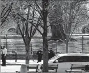  ?? AP ?? US Secret Service officers stand in the cordoned off area on Pennsylvan­ia Avenue after a security incident near the fence of the White House in Washington on March 18. President Trump was not at the White House at the time.