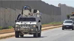  ?? MOHAMMED ZAATARI/AP ?? Spanish U.N peacekeepe­rs patrol the Lebanese-Israeli border in Kfar Kila, Lebanon, on Monday. Lebanon’s National News Agency reported that Israeli drones attacked a Palestinia­n base near the country’s border with Syria.