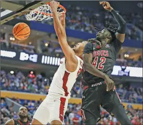  ?? Charlie Kaijo/NWA Democrat-Gazette ?? Slammed: Arkansas forward Jaylin Williams (10) dunks, Saturday, March 19, 2022, during the first half of the second round of the 2022 NCAA Division I Men's NCAA Tournament game against New Mexico State at KeyBank Center in Buffalo, N.Y.
