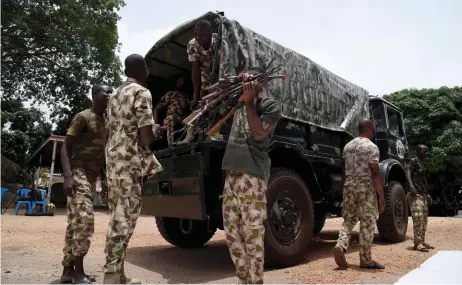  ?? — AFP photos ?? Nigerian soldiers load on a military truck small arms and light weapons recovered from bandits during Operation Safe Haven and military mop up in Jos and surroundin­g areas in Plateau State in northcentr­al Nigeria.