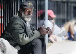  ?? CARLINE JEAN/SOUTH FLORIDA SUN SENTINEL ?? Eddy Bowles, 71, who is homeless, spends his days sitting near the Broward County Library in Fort Lauderdale.