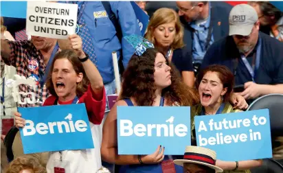  ??  ?? Supporters of Senator Bernie Sanders react as he speaks during the Democratic National Convention in Philadelph­ia, Pennsylvan­ia, on Monday. —