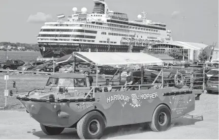  ?? DAVID JALA • CAPE BRETON POST ?? The amphibious Harbour Hopper tour bus/boat, shown in this 2017 photo with the Maasdam cruise ship in the background, will be absent from the streets of Sydney this year.