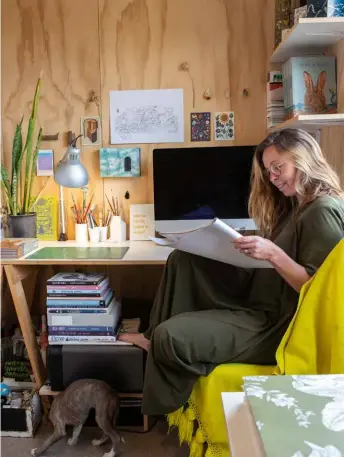  ??  ?? WORK SPACE Laura works from a nook lined with plywood in the garage. For inspiratio­n, the window looks over the veggie garden and to the mountains beyond.