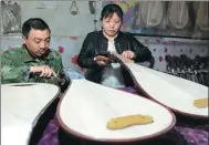  ?? MIAO YUCAI / FOR CHINA DAILY ?? Xu Huiping and his wife make pipa at their workshop in Lankao, Henan province.