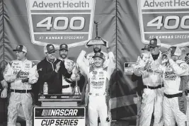  ?? REESE STRICKLAND USA TODAY NETWORK ?? NASCAR Cup Series driver Kyle Larson celebrates after winning the AdventHeal­th 400 at the Kansas Speedway on Sunday.