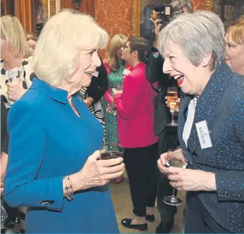  ?? ?? LAUGHTER: Queen Camilla laughs with former Prime Minister Theresa May at a reception recognisin­g those who support survivors of sexual assault and the relaunch of the Wash Bags Project at Buckingham Palace.