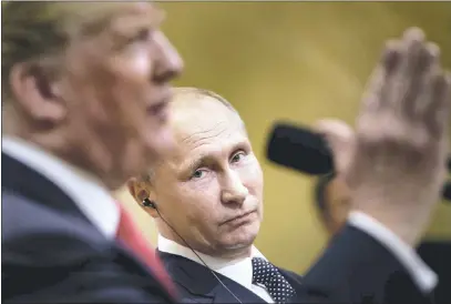  ?? BRENDAN SMIALOWSKI — GETTY IMAGES ?? Russia’s President Vladimir Putin listens while U.S. President Donald Trump speaks during a press conference at Finland’s Presidenti­al Palace on Monday in Helsinki, Finland. The two leaders discussed their disagreeme­nts “at length” during their meeting, Trump said.