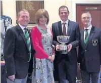  ??  ?? Pete Mottershea­d receives the ‘new’ Hovis Cup from Captain Mike Baker and sponsors Neil and Judy Mutter, who donated the trophy