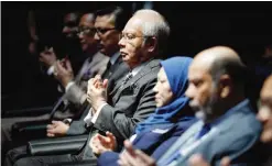  ??  ?? KUALA LUMPUR: Malaysian Prime Minister Najib Razak, center, prays during the launching of east coast railway trains event. — AP