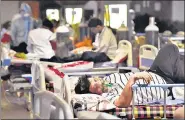  ?? AJAY AGGARWAL /HT PHOTO ?? People admitted in the temporary Covid-19 care facility attached to LNJP Hospital in Delhi on Friday.