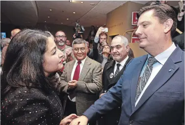  ?? CLIFFORD SKARSTEDT EXAMINER ?? Re-elected Peterborou­ghKawartha Liberal candidate Maryam Monsef shakes hands with Conservati­ve candidate Michael Skinner after he conceded his loss at Showplace Performanc­e Centre late Monday night.