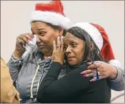  ?? PHIL MASTURZO / BEACON JOURNAL ?? Traci Higginbott­om-Williams (left) and friend Tammy Palmer shed a few tears after a television interview describing stolen Toys for Tots donations at First Apostolic Faith Church in Akron.
