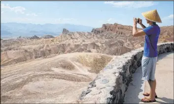  ?? Ellen Schmidt Las Vegas Review-Journal @ellenkschm­idttt ?? Peter Vukasin snaps a photo at Zabriskie Point in Death Valley National Park as temperatur­es reached 127 degrees on Aug. 17.