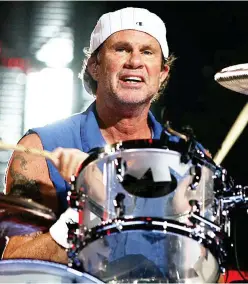  ??  ?? Left: Red Hot Chili Peppers drummer Chad Smith in a concert.