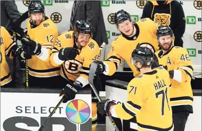  ?? Elise Amendola / Associated Press ?? Boston Bruins left wing Taylor Hall (71) celebrates his goal with teammates on the bench in the third period against the Islanders on Thursday.