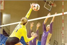  ?? Photo courtesy of JBU Sports Informatio­n ?? John Brown freshman opposite side hitter Megan Beck, left, tries to hit around Southweste­rn Assemblies of God (Texas) blockers Faith Pittman and Kali Shaw during Saturday’s match at Bill George Arena. The Golden Eagles defeated the Lions 3-1.