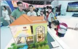  ?? PROVIDED TO CHINA DAILY ?? Visitors look at a model of a smart home at an industry expo in Guangzhou, capital of Guangdong province.