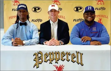  ?? Contribute­d ?? Pepperell seniors Marquedon Watkins (from left), Trevor Thomas and Bryan Williams sit at the table where they signed to play college football in the fall. The trio are part a big senior class for the Dragons that is set to play at the next level.
