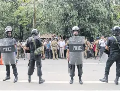  ?? AP ?? Riot policemen stand guard as a no-confidence vote takes place in parliament in Colombo, Sri Lanka.