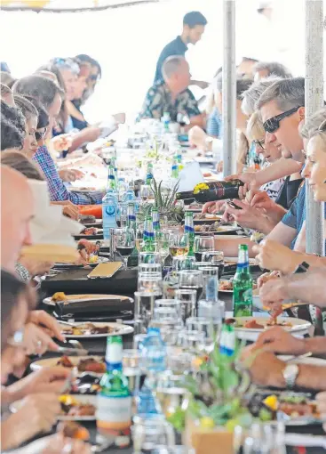  ?? Picture: JUSTIN BRIERTY ?? DECADENT: Guests enjoy food and wine at the Port Douglas Carnivale Longest Lunch in Rex Smeal Park yesterday.