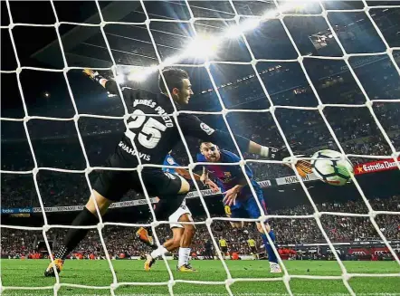  ??  ?? No joy: Barcelona’s Lionel Messi heading the ball into the net in the match against Malaga at the Nou Camp on Saturday. The goal was later disallowed. — Reuters