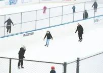  ?? NATHAN DENETTE / THE CANADIAN PRESS ?? Skaters keep their distance at a rink in Toronto.