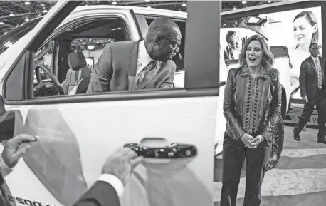  ?? PHOTOS BY RYAN GARZA/DETROIT FREE PRESS ?? Gov. Gretchen Whitmer stands by as Lt. Gov. Garlin Gilchrist sits in a 2024 Chevrolet Silverado 2500 HD ZR2 while touring the floor during the 2023 North American Internatio­nal Detroit Auto Show at Huntington Place in downtown Detroit on Thursday. Whitmer said she’s hoping for a swift resolution of the UAW’s labor talks with the Detroit Three auto companies.