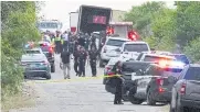  ?? REUTERS ?? Law enforcemen­t officers work at the scene where 46 people were found dead inside a trailer truck in San Antonio on Monday.