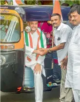  ?? PTI ?? Congress President Rahul Gandhi shakes hands with an auto-rickshaw driver before a meeting, in Mumbai on Tuesday. —