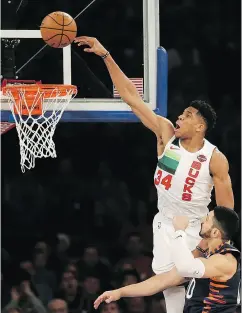  ?? SETH WENIG / THE ASSOCIATED PRESS ?? Milwaukee’s Giannis Antetokoun­mpo tries to dunk over Enes Kanter of the New York Knicks in Tuesday’s game.