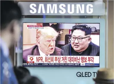  ?? JEAN CHUNG / BLOOMBERG ?? South Koreans watch a news report featuring images of U.S. President Donald Trump and North Korean leader Kim Jong Un in Seoul on Friday.